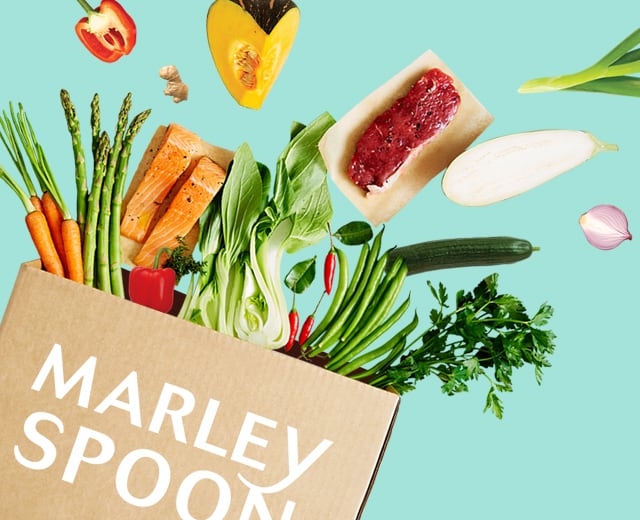 Marley Spoon måltidskasse med friske ingredienser der kommer flyvende ud af kassen